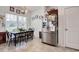 Cozy dining area featuring a window view, tile floors, and stainless steel refrigerator at 321 Galway Ct., Longs, SC 29568