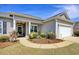 Inviting front exterior featuring a walkway with manicured landscaping and a covered entryway at 321 Galway Ct., Longs, SC 29568