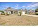 Attractive single-story home with a manicured lawn and a young palm tree in the front yard at 321 Galway Ct., Longs, SC 29568