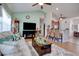 Cozy living room featuring wood flooring, a ceiling fan, and an adjacent kitchen bar with seating at 321 Galway Ct., Longs, SC 29568
