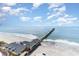 An aerial view of the coastline with a pier and building on the beach at 3500 N Ocean Blvd. # 902, North Myrtle Beach, SC 29582