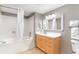 Well-lit bathroom featuring a shower-tub combination, light wood cabinet, and a large mirror at 3500 N Ocean Blvd. # 902, North Myrtle Beach, SC 29582