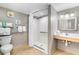 Accessible bathroom features a walk-in shower, grab bars, and a vanity with ample lighting at 3500 N Ocean Blvd. # 902, North Myrtle Beach, SC 29582