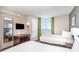 Relaxing bedroom featuring two beds, a dresser with television, and a stunning ocean view at 3500 N Ocean Blvd. # 902, North Myrtle Beach, SC 29582