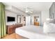 Bright bedroom features a ceiling fan, dresser with television, and access to the bathroom at 3500 N Ocean Blvd. # 902, North Myrtle Beach, SC 29582