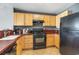 Efficient kitchen with wooden cabinets, black appliances, and red countertops at 3500 N Ocean Blvd. # 902, North Myrtle Beach, SC 29582