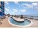 Exterior shot of rooftop lazy river with ocean view, lounge chairs, and beautiful blue sky at 3500 N Ocean Blvd. # 902, North Myrtle Beach, SC 29582