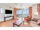Cozy living room with ocean views, ceiling fan, TV, balcony access, and comfortable seating at 3500 N Ocean Blvd. # 902, North Myrtle Beach, SC 29582