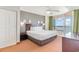 Serene main bedroom with a king-size bed, ceiling fan, balcony access, and stunning ocean views at 3500 N Ocean Blvd. # 902, North Myrtle Beach, SC 29582