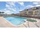 Exterior shot of a large pool with clear water, a hot tub, and lounge chairs, perfect for relaxation at 3500 N Ocean Blvd. # 902, North Myrtle Beach, SC 29582