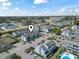 Aerial view of condominium complex showcasing parking, landscaping, and community amenities under a sunny sky at 3700 Golf Colony Lane # 13-H, Little River, SC 29566