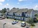 Attractive condominium complex with parking and inviting front entrances under a cloudy blue sky at 3700 Golf Colony Lane # 13-H, Little River, SC 29566
