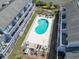 Aerial view showing a pool with seating next to condo balconies at 3700 Golf Colony Lane # 13-H, Little River, SC 29566