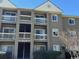 Three-story condo building with balconies and neutral siding on a sunny day at 380-K Myrtle Greens Dr. # 380-K, Conway, SC 29526