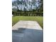 New backyard patio provides a peaceful outdoor retreat with lush green lawn and privacy hedges at 382 Waties Dr., Murrells Inlet, SC 29576