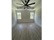 A spacious bedroom features tray ceiling, recessed lights, new floors, and natural light from the double windows at 382 Waties Dr., Murrells Inlet, SC 29576