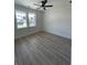 An airy bedroom with modern ceiling fan, beautiful floors and plenty of natural light from two large windows at 382 Waties Dr., Murrells Inlet, SC 29576