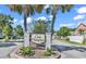 Charming Oak Hampton community entrance with manicured landscaping and palm trees at 382 Waties Dr., Murrells Inlet, SC 29576