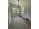 Dining room featuring neutral paint, modern chandelier, hardwood floors and large windows for natural light at 382 Waties Dr., Murrells Inlet, SC 29576