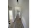 Long hallway with hardwood floors and white trim throughout at 382 Waties Dr., Murrells Inlet, SC 29576