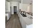 Eat-in kitchen with bright white cabinets, neutral countertops and a stainless steel sink and modern faucet at 382 Waties Dr., Murrells Inlet, SC 29576