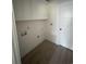 Functional laundry room with overhead cabinets, new flooring, and utility connections, offering convenience and practicality at 382 Waties Dr., Murrells Inlet, SC 29576