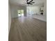 Spacious living room with hardwood floors, modern lighting, sliding glass doors and an open floor plan at 382 Waties Dr., Murrells Inlet, SC 29576