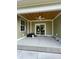 Covered patio area with a ceiling fan and sliding glass door provides a relaxing outdoor space at 382 Waties Dr., Murrells Inlet, SC 29576
