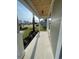 View of a covered porch with a wooden ceiling and modern light fixture at 382 Waties Dr., Murrells Inlet, SC 29576