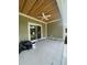 Covered porch area with a ceiling fan and sliding glass door provides a relaxing outdoor space at 382 Waties Dr., Murrells Inlet, SC 29576