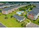Aerial view of a vibrant community, swimming pool, pond, and lush greenery at 3927 Gladiola Ct. # 101, Myrtle Beach, SC 29588