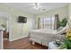 This bedroom features wood floors and a large window providing natural light at 3927 Gladiola Ct. # 101, Myrtle Beach, SC 29588