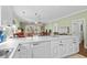 Bright, open kitchen featuring white cabinets and appliances, with views to dining and living room at 3927 Gladiola Ct. # 101, Myrtle Beach, SC 29588