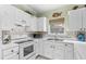 Well-maintained kitchen features white appliances, ample counter space, and decorative tile backsplash at 3927 Gladiola Ct. # 101, Myrtle Beach, SC 29588