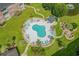 Aerial view of a community pool with palm trees and lounge chairs at 3927 Gladiola Ct. # 101, Myrtle Beach, SC 29588