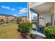 Porch with seating overlooks lush green lawn, pond, and other condo buildings at 3927 Gladiola Ct. # 101, Myrtle Beach, SC 29588