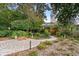 Landscaped backyard featuring a brick patio, winding pathways, and lush greenery, creating a serene outdoor space at 404 66Th Ave. N, Myrtle Beach, SC 29572