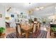 Bright open-concept with a dining area adjacent to an island kitchen with white cabinets and modern lighting at 404 66Th Ave. N, Myrtle Beach, SC 29572