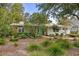 Charming single-story home with a lush, landscaped front yard and a welcoming teal front door at 404 66Th Ave. N, Myrtle Beach, SC 29572