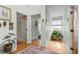 Bright hallway with hardwood floors and decorative plants, leading to a bathroom and other rooms at 404 66Th Ave. N, Myrtle Beach, SC 29572
