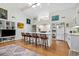 Bright kitchen with a kitchen island, skylight, and white cabinets adjoining an open living area at 404 66Th Ave. N, Myrtle Beach, SC 29572