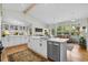 Spacious kitchen with white cabinets and a large island that flows into an open living and dining area at 404 66Th Ave. N, Myrtle Beach, SC 29572