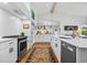 Modern kitchen with white cabinets, stainless steel appliances, and a large island at 404 66Th Ave. N, Myrtle Beach, SC 29572