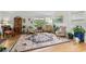 Elegant living room featuring a large area rug, wood floors, and ample natural light from the large window at 404 66Th Ave. N, Myrtle Beach, SC 29572