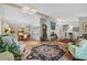 Open-concept living room with hardwood floors, skylights, and an adjoining dining and kitchen area at 404 66Th Ave. N, Myrtle Beach, SC 29572