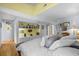 Bright and airy main bedroom with built-in shelving, closet and sunny yellow accent wall with hardwood floors at 404 66Th Ave. N, Myrtle Beach, SC 29572