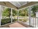 Inviting screened porch with brick flooring, offering a relaxing view of the garden and ample natural light at 404 66Th Ave. N, Myrtle Beach, SC 29572