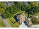 Aerial view showcases the home's layout, large lot, mature trees, and neighborhood at 404 Club Dr., Myrtle Beach, SC 29572