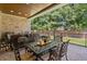 Covered back patio features brick floor and ceiling, wrought iron furniture, and manicured yard at 404 Club Dr., Myrtle Beach, SC 29572
