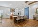Bright kitchen featuring a large island with seating, stylish lighting, and modern appliances at 404 Club Dr., Myrtle Beach, SC 29572